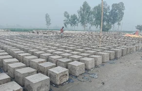 Concrete pipeline weights laid out on site