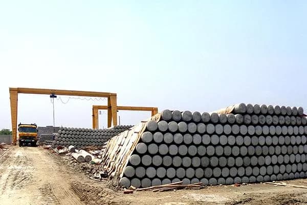 Finished poles stacked under gantry cranes